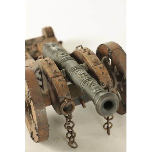 732 - A 20TH CENTURY BRONZE MODEL OF A CANNON mounted on a wooden carriage with steel decoration (37cm wid... 