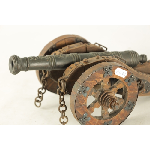 732 - A 20TH CENTURY BRONZE MODEL OF A CANNON mounted on a wooden carriage with steel decoration (37cm wid... 