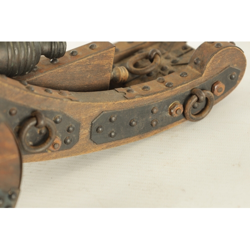 732 - A 20TH CENTURY BRONZE MODEL OF A CANNON mounted on a wooden carriage with steel decoration (37cm wid... 