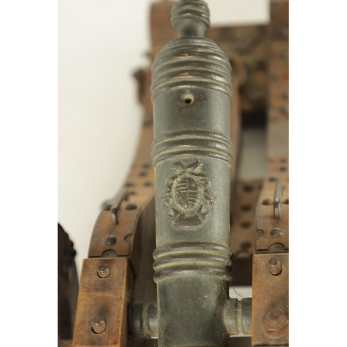 732 - A 20TH CENTURY BRONZE MODEL OF A CANNON mounted on a wooden carriage with steel decoration (37cm wid... 