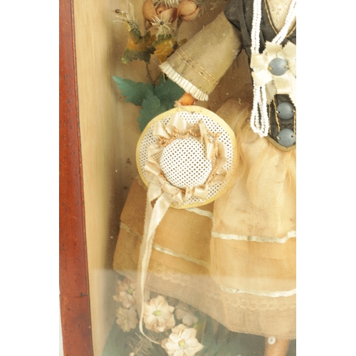 757 - A 19TH CENTURY WAX OVER DOLL FIGURE IN A GLAZED DISPLAY CABINET in full dress with floral decoration... 