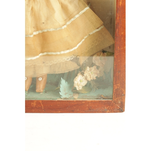 757 - A 19TH CENTURY WAX OVER DOLL FIGURE IN A GLAZED DISPLAY CABINET in full dress with floral decoration... 