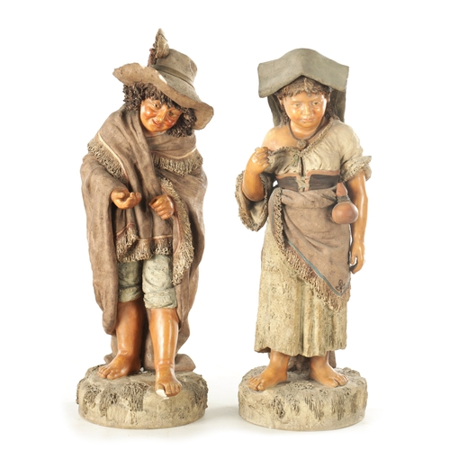 765 - A LARGE PAIR OF 19TH CENTURY POLYCHROME TERRACOTTA FIGURES modelled as a young boy and girl on natur... 