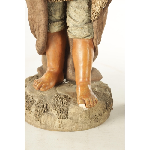 765 - A LARGE PAIR OF 19TH CENTURY POLYCHROME TERRACOTTA FIGURES modelled as a young boy and girl on natur... 