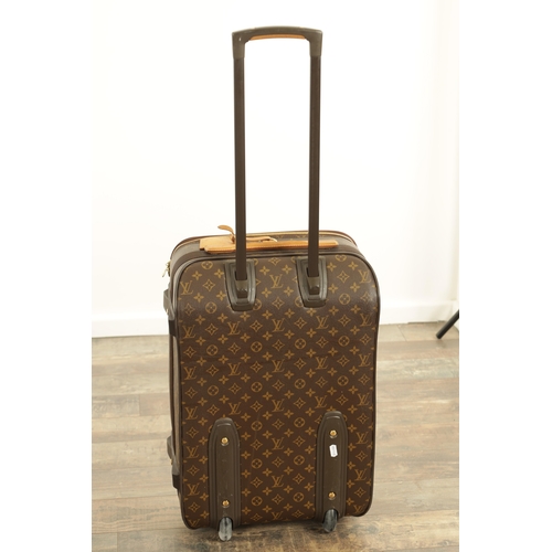 766 - A GENUINE LOUIS VUITTON CABIN SUITCASE with monogrammed decoration and brown leather carrying handle... 