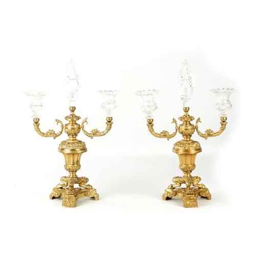 776 - A PAIR OF LATE 19TH CENTURY REGENCY STYLE FRENCH ORMOLU AND CUT GLASS CANDELABRA with twin candle sc... 