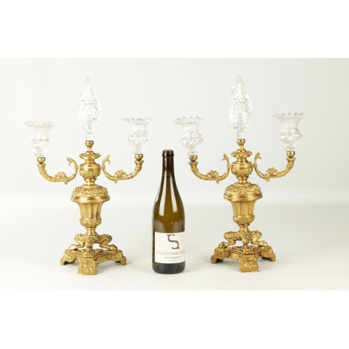 776 - A PAIR OF LATE 19TH CENTURY REGENCY STYLE FRENCH ORMOLU AND CUT GLASS CANDELABRA with twin candle sc... 