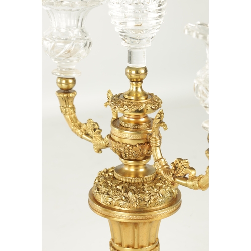 776 - A PAIR OF LATE 19TH CENTURY REGENCY STYLE FRENCH ORMOLU AND CUT GLASS CANDELABRA with twin candle sc... 