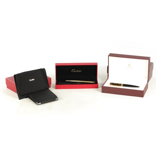 777 - A CARTIER PEN, CARTIER WALLET TOGETHER WITH AN AIGNER PEN in original boxes