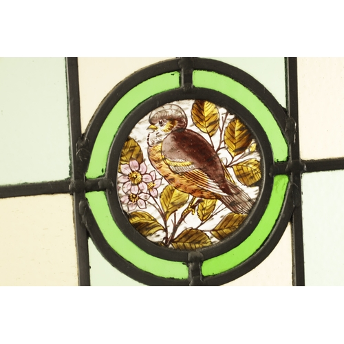 779 - A LATE 19TH CENTURY LEADED COLOURED STAIN GLASS WINDOW of square panels enclosing a central bird and... 