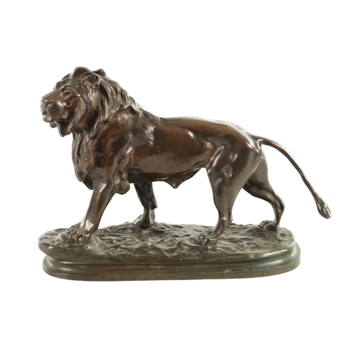 785 - A 19TH CENTURY BROWN PATINATED STANDING BRONZE LION on a naturalistic, earthy base and plain moulded... 