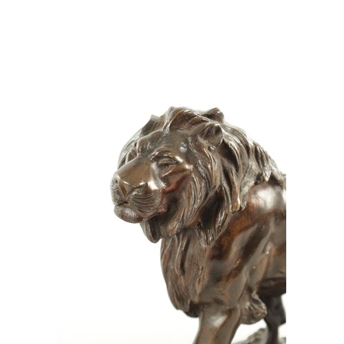 785 - A 19TH CENTURY BROWN PATINATED STANDING BRONZE LION on a naturalistic, earthy base and plain moulded... 