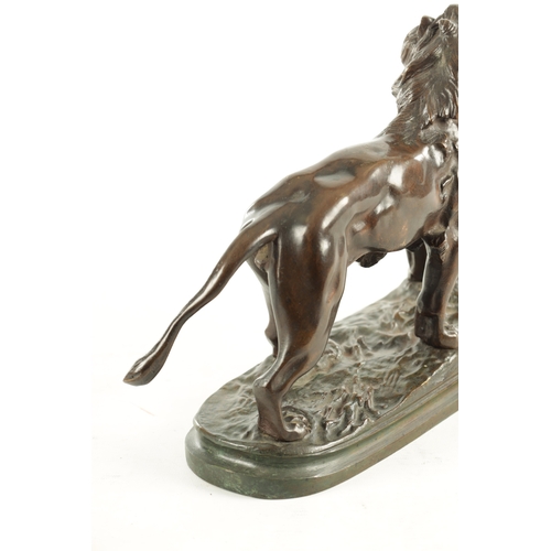 785 - A 19TH CENTURY BROWN PATINATED STANDING BRONZE LION on a naturalistic, earthy base and plain moulded... 