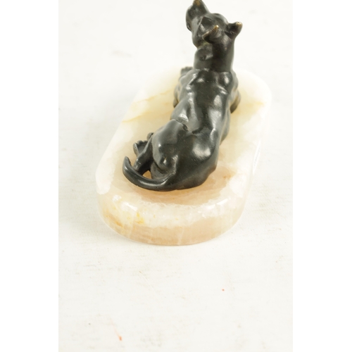 791 - A 19TH CENTURY FRENCH BRONZE AND WHITE ONYX RECUMBENT DOG DESK PAPERWEIGHT with dark green patinated... 