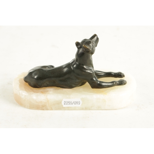 791 - A 19TH CENTURY FRENCH BRONZE AND WHITE ONYX RECUMBENT DOG DESK PAPERWEIGHT with dark green patinated... 