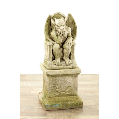 795 - A MODERN COMPOSITE STONE GARDEN STATUE MODELLED AS THE DEVIL seated in a chair raised on a square pl... 