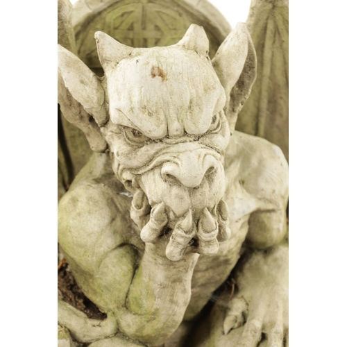 795 - A MODERN COMPOSITE STONE GARDEN STATUE MODELLED AS THE DEVIL seated in a chair raised on a square pl... 