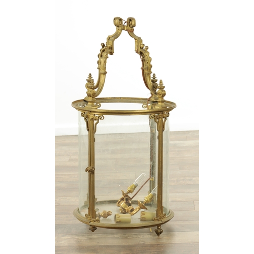 803 - A LARGE 20TH CENTURY GILT BRASS HANGING HALL LANTERN having leaf cast circular frame and glazed hing... 