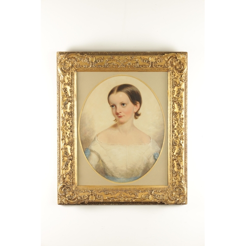 812 - A 19TH CENTURY OIL ON BOARD HALF-LENGTH PORTRAIT OF A YOUNG LADY mounted in a glazed gilt moulded fr... 