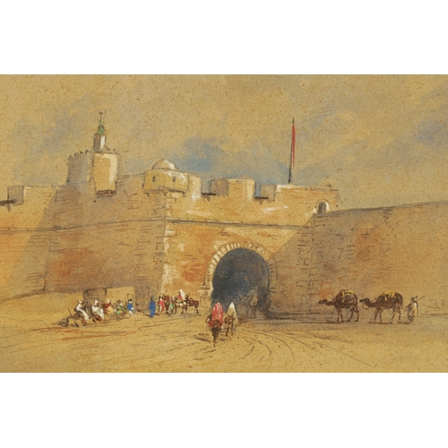 881 - A LATE 19TH CENTURY WATERCOLOUR depicting a North African scene with camels and figures by a castle ... 