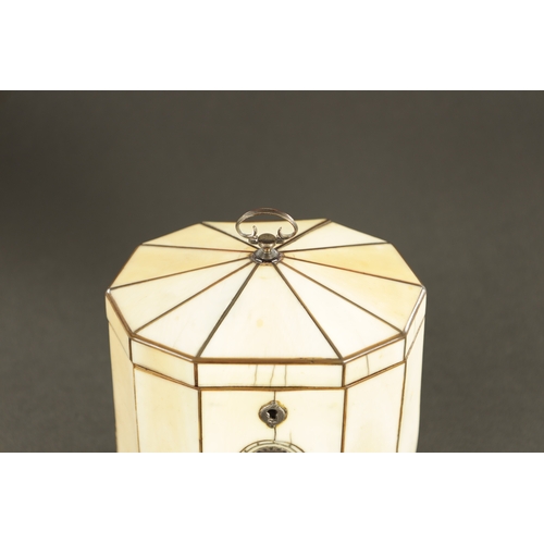 887 - A GEORGE III IVORY VENEERED AND HORN STRUNG TENT TOP TEA CADDY with silver axe drop handle and oval ... 