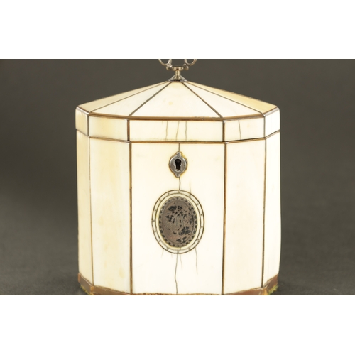 887 - A GEORGE III IVORY VENEERED AND HORN STRUNG TENT TOP TEA CADDY with silver axe drop handle and oval ... 