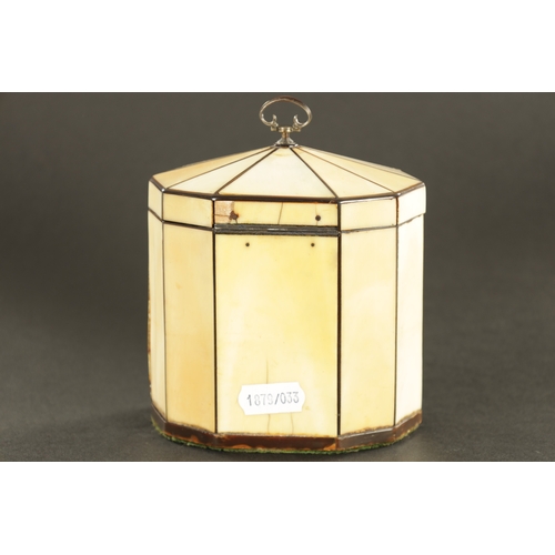 887 - A GEORGE III IVORY VENEERED AND HORN STRUNG TENT TOP TEA CADDY with silver axe drop handle and oval ... 