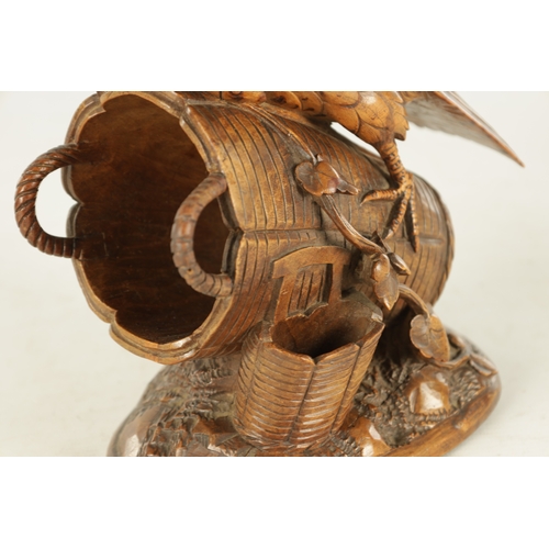 889 - A 19TH CENTURY BLACK FOREST CARVED LINDEN WOOD SCULPTURE depicting a bird sat on a basket - with gla... 