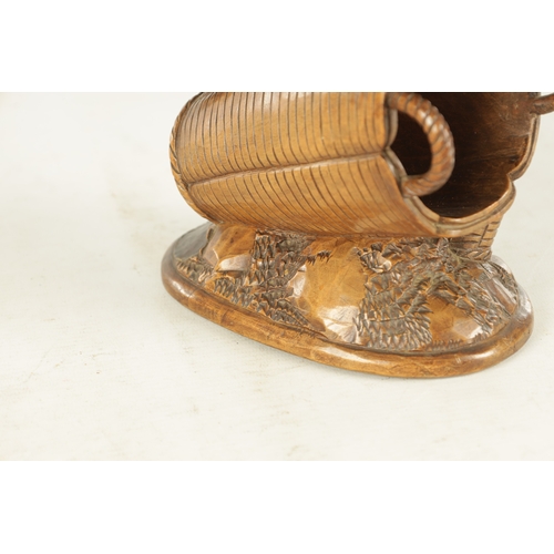 889 - A 19TH CENTURY BLACK FOREST CARVED LINDEN WOOD SCULPTURE depicting a bird sat on a basket - with gla... 