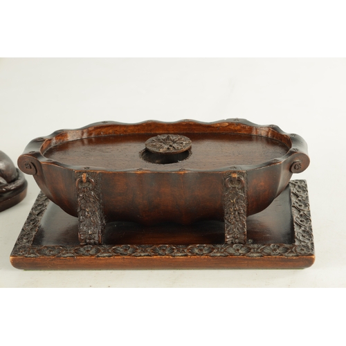 890 - A RARE 19TH CENTURY CARVED WALNUT BLACK FOREST INKWELL formed as a recumbent greyhound raised on a s... 