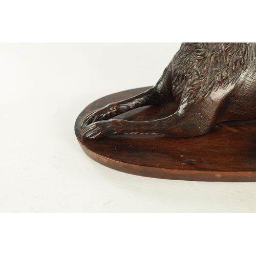 890 - A RARE 19TH CENTURY CARVED WALNUT BLACK FOREST INKWELL formed as a recumbent greyhound raised on a s... 