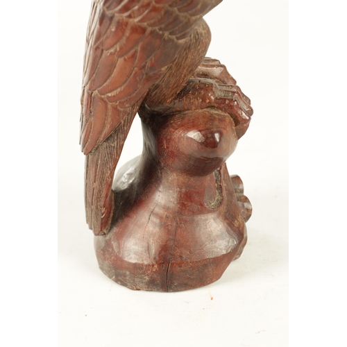 897 - A LATE 19TH CENTURY CARVED SCULPTURE OF AN EAGLE with glass eyes, standing on a naturalistic base. (... 