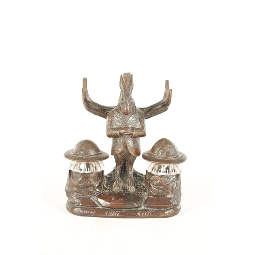 900 - A GOOD 19TH CENTURY BLACK FOREST CARVED LINDEN WOOD INKSTAND formed as a standing hare with branchwo... 