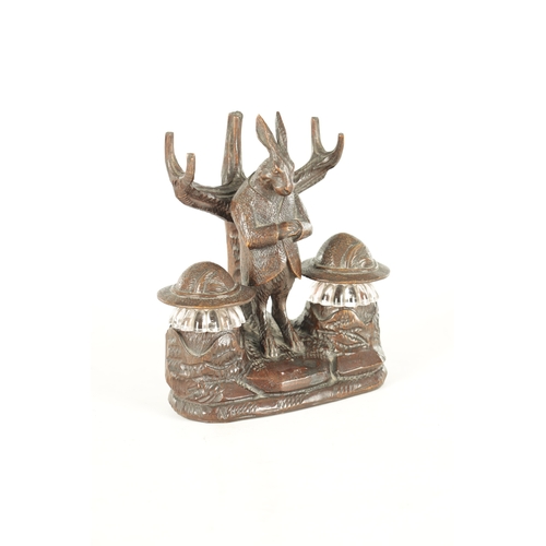 900 - A GOOD 19TH CENTURY BLACK FOREST CARVED LINDEN WOOD INKSTAND formed as a standing hare with branchwo... 