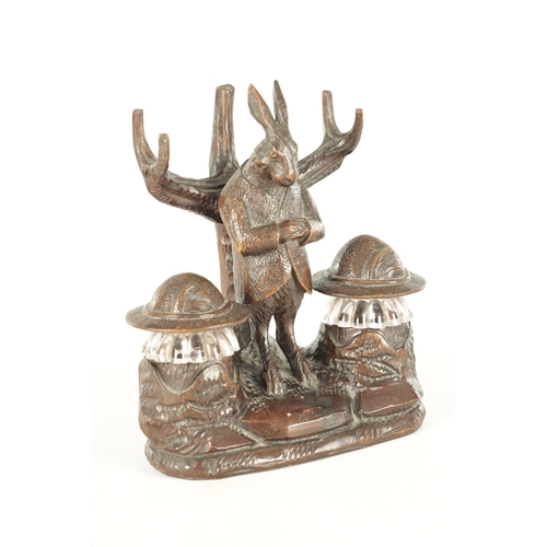 900 - A GOOD 19TH CENTURY BLACK FOREST CARVED LINDEN WOOD INKSTAND formed as a standing hare with branchwo... 