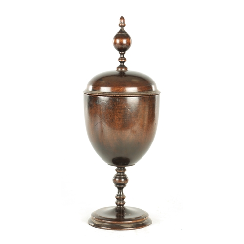 904 - A 17TH CENTURY STYLE TURNED WALNUT ALTER CHALICE AND COVER having turned finial above a bulbous body... 