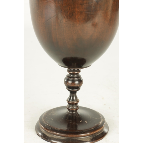 904 - A 17TH CENTURY STYLE TURNED WALNUT ALTER CHALICE AND COVER having turned finial above a bulbous body... 