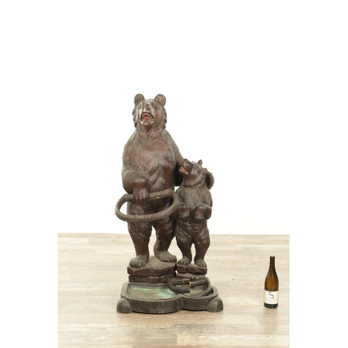 910 - A LATE 19TH CENTURY CARVED BLACK FOREST BEAR AND CUB STICK STAND modelled as a standing bear with he... 