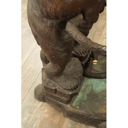 910 - A LATE 19TH CENTURY CARVED BLACK FOREST BEAR AND CUB STICK STAND modelled as a standing bear with he... 