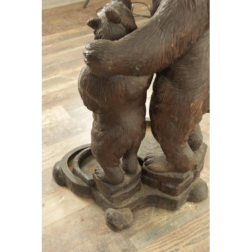 910 - A LATE 19TH CENTURY CARVED BLACK FOREST BEAR AND CUB STICK STAND modelled as a standing bear with he... 