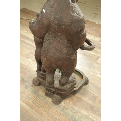 910 - A LATE 19TH CENTURY CARVED BLACK FOREST BEAR AND CUB STICK STAND modelled as a standing bear with he... 