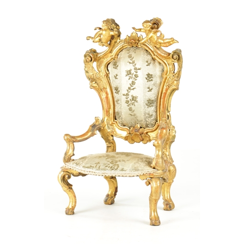 912 - A RARE 18TH CENTURY CARVED GILT-WOOD MINIATURE CHAIR with cherub cresting and leaf-carved frame rais... 