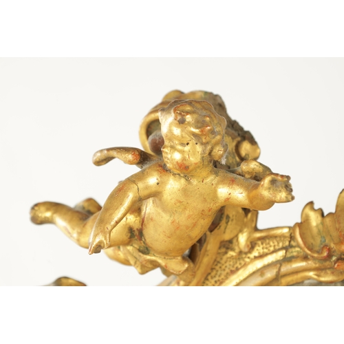 912 - A RARE 18TH CENTURY CARVED GILT-WOOD MINIATURE CHAIR with cherub cresting and leaf-carved frame rais... 