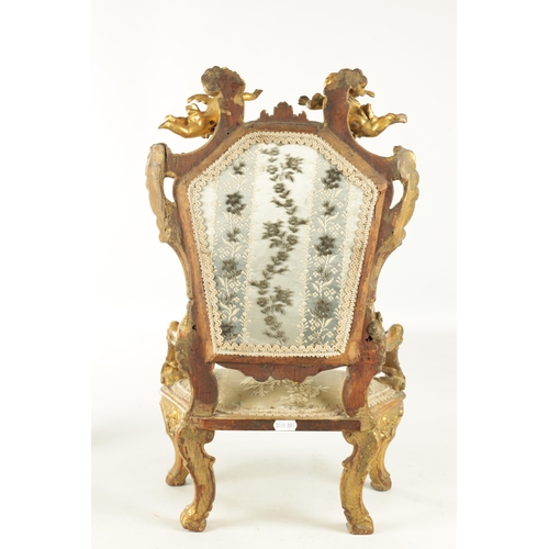 912 - A RARE 18TH CENTURY CARVED GILT-WOOD MINIATURE CHAIR with cherub cresting and leaf-carved frame rais... 