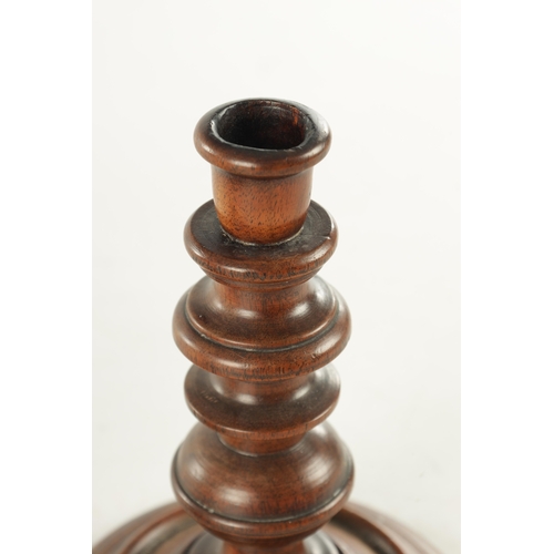 913 - A PAIR OF 19TH CENTURY TURNED WALNUT TREENWARE CANDLESTICKS having knopped turned stems and dished b... 