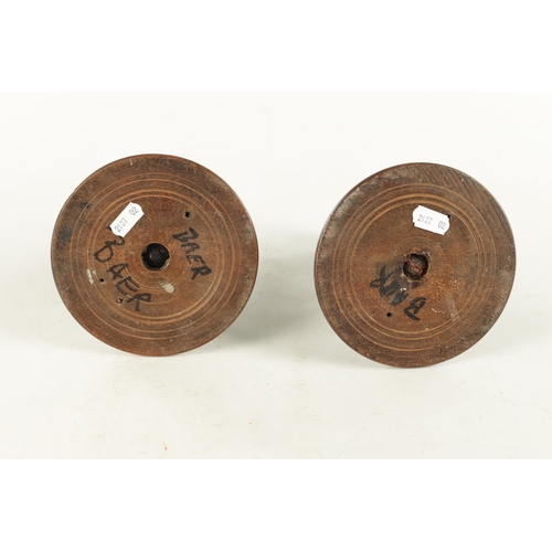 913 - A PAIR OF 19TH CENTURY TURNED WALNUT TREENWARE CANDLESTICKS having knopped turned stems and dished b... 