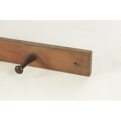 918 - JOHN HOWARD & SO, LONDON. A 19TH CENTURY MAHOGANY HANGING COAT HOOK having four turned pegs stamped ... 