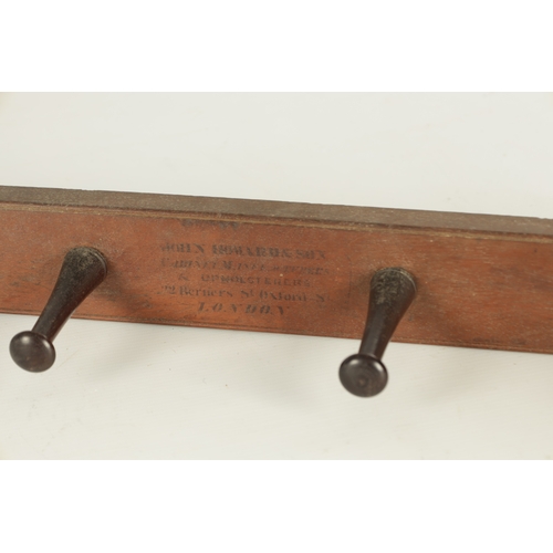 918 - JOHN HOWARD & SO, LONDON. A 19TH CENTURY MAHOGANY HANGING COAT HOOK having four turned pegs stamped ... 