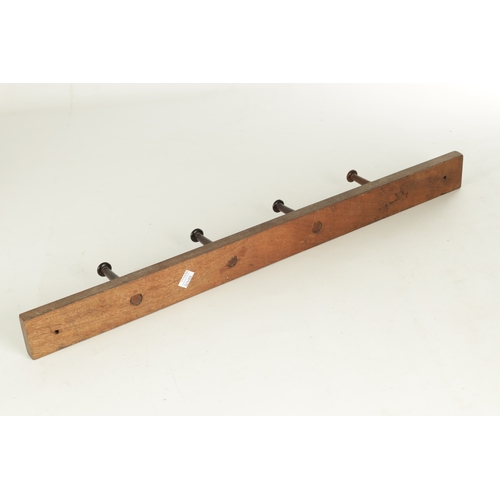 918 - JOHN HOWARD & SO, LONDON. A 19TH CENTURY MAHOGANY HANGING COAT HOOK having four turned pegs stamped ... 