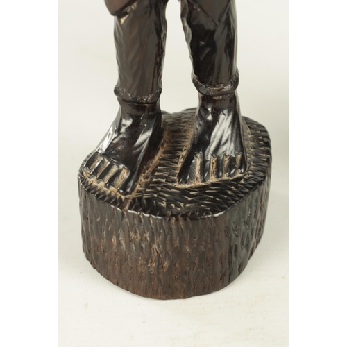 921 - A 20TH CENTURY AFRICAN CARVED EBONY FIGURE OF A SLAVE (33cm high)